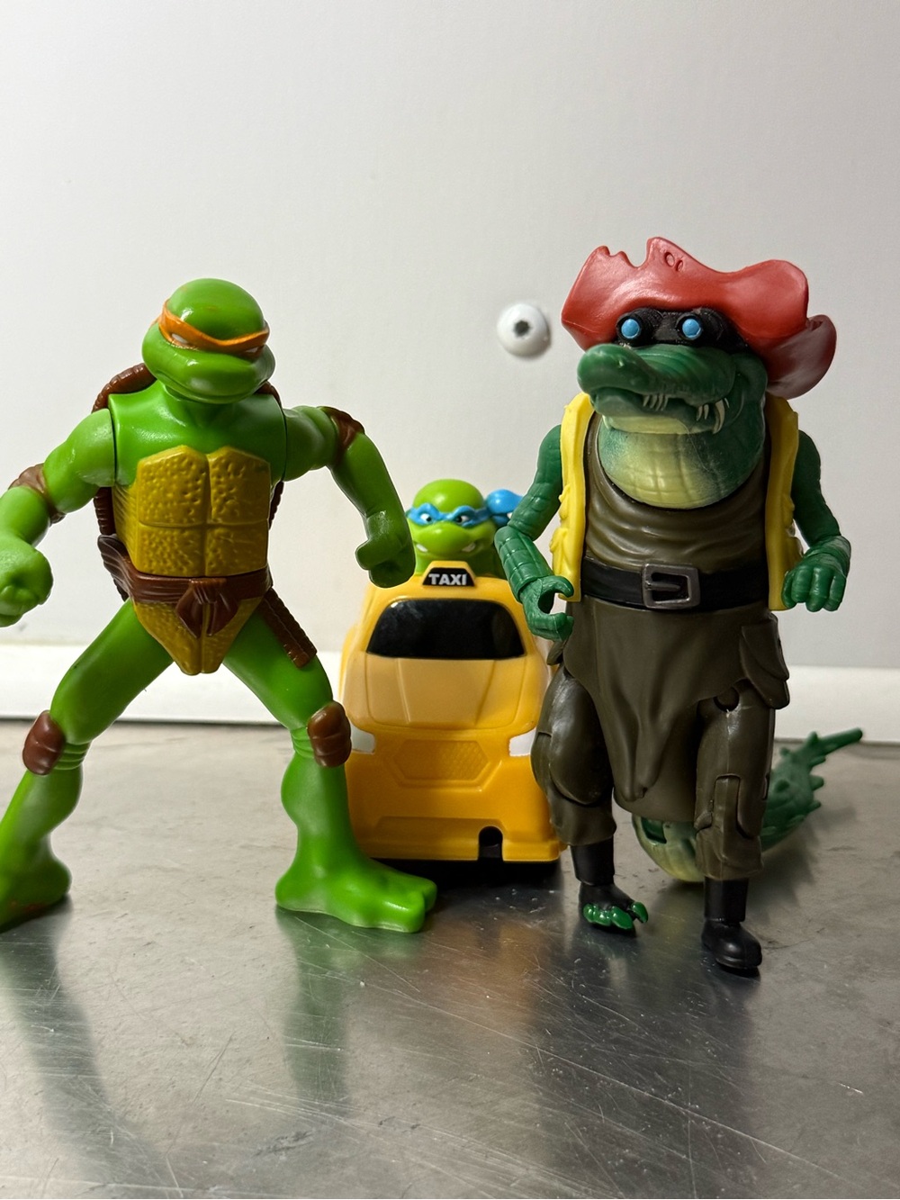 3 Ninja Turtle Action Figures with Yellow Taxi Toy